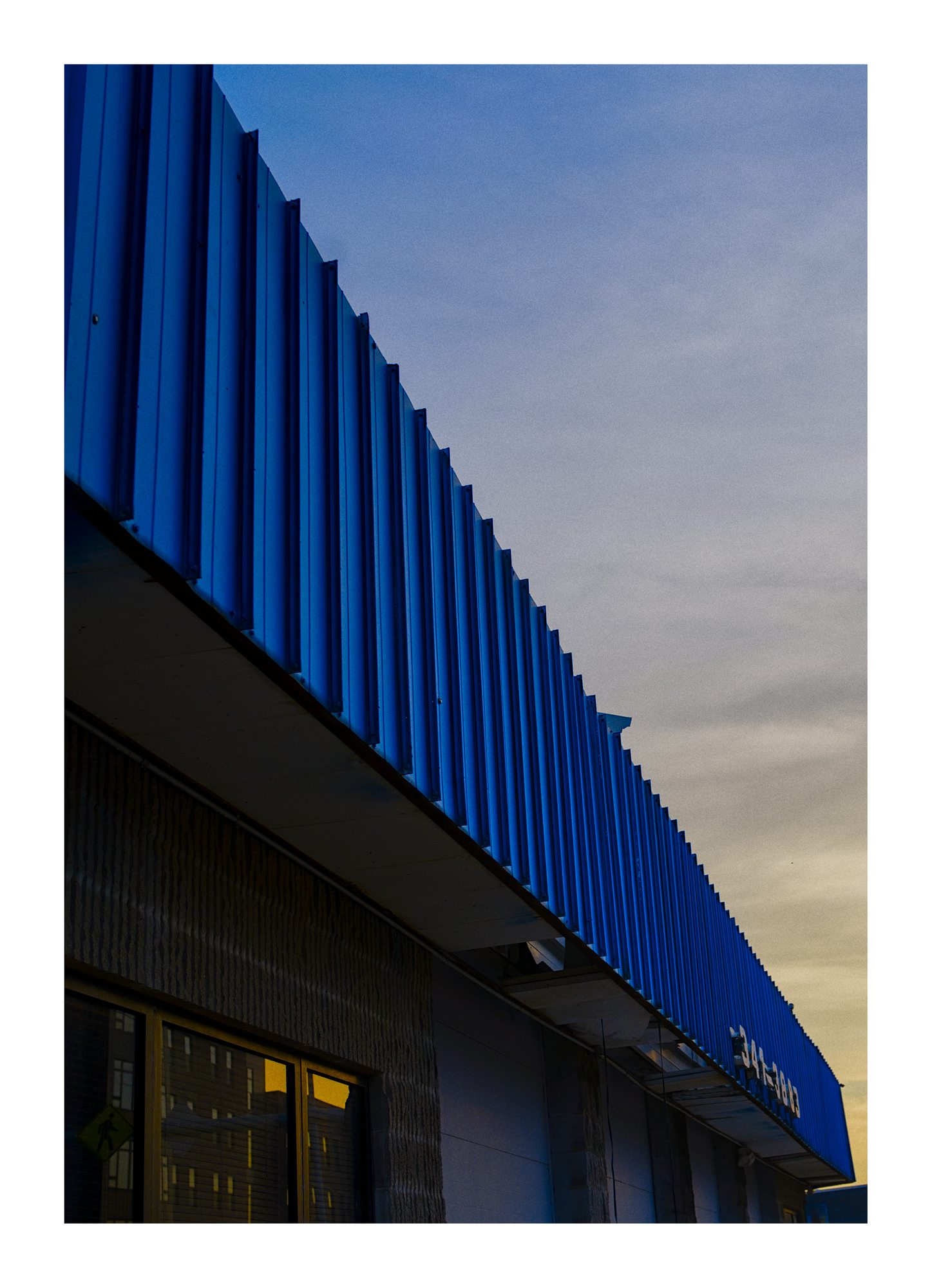 A blue building edge in evening light.