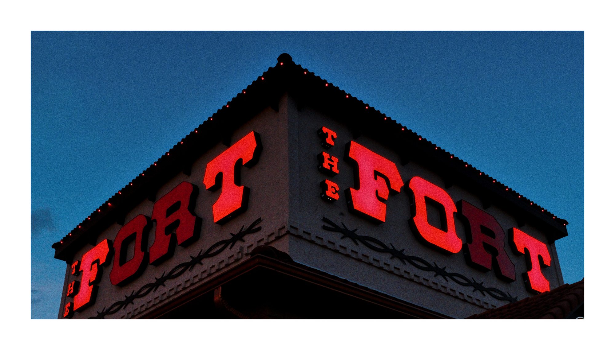 A red Fort sign on a building corner.