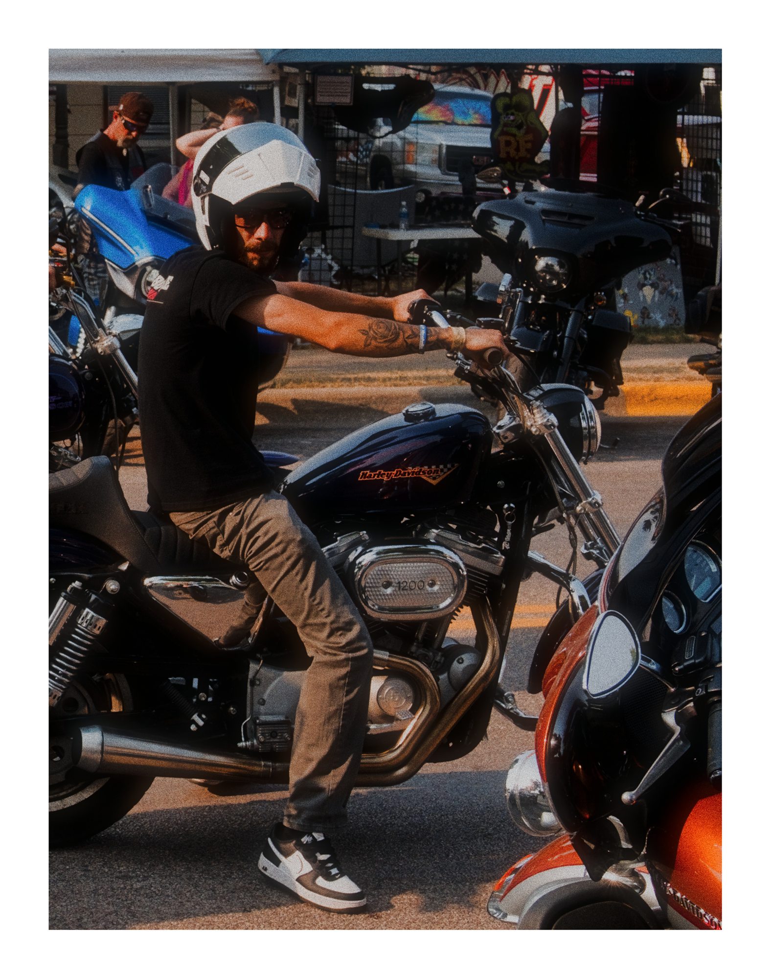 A rider sitting on a motorcycle in busy rally traffic.