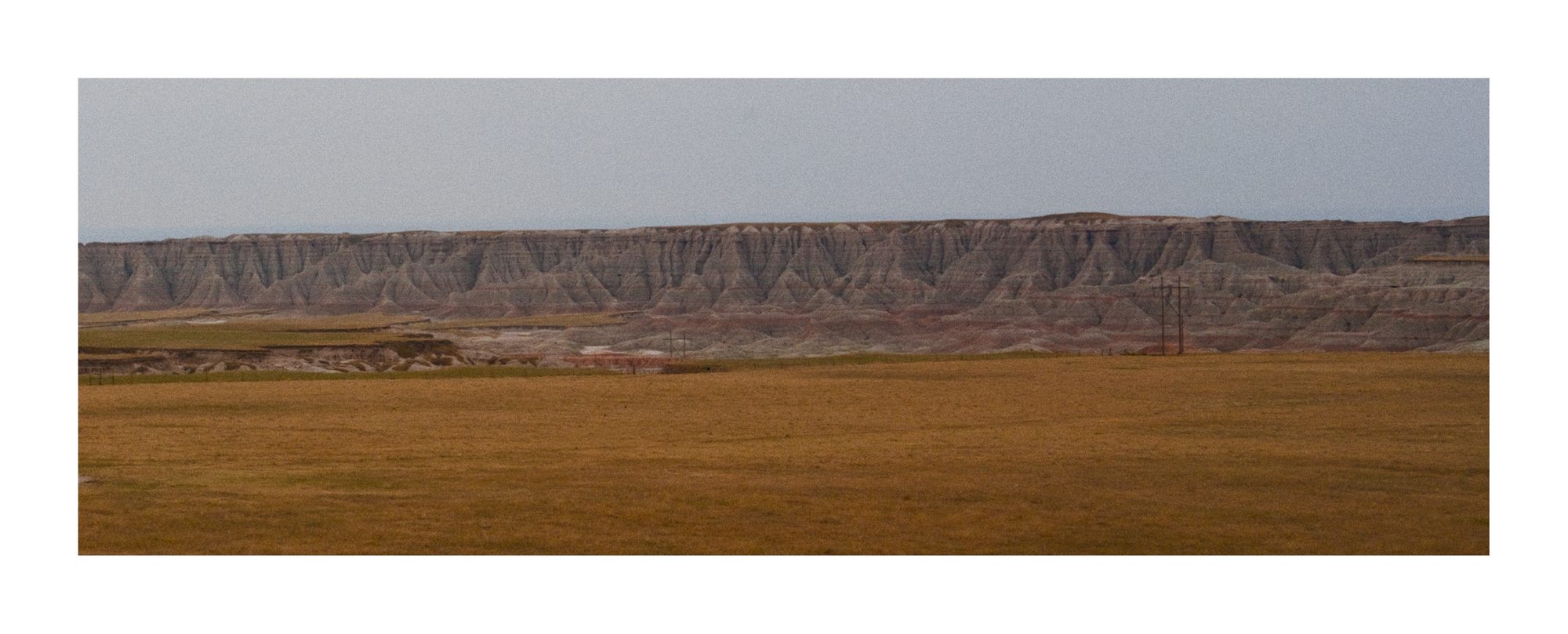 A wide view of layered South Dakota hills under a pale sky.