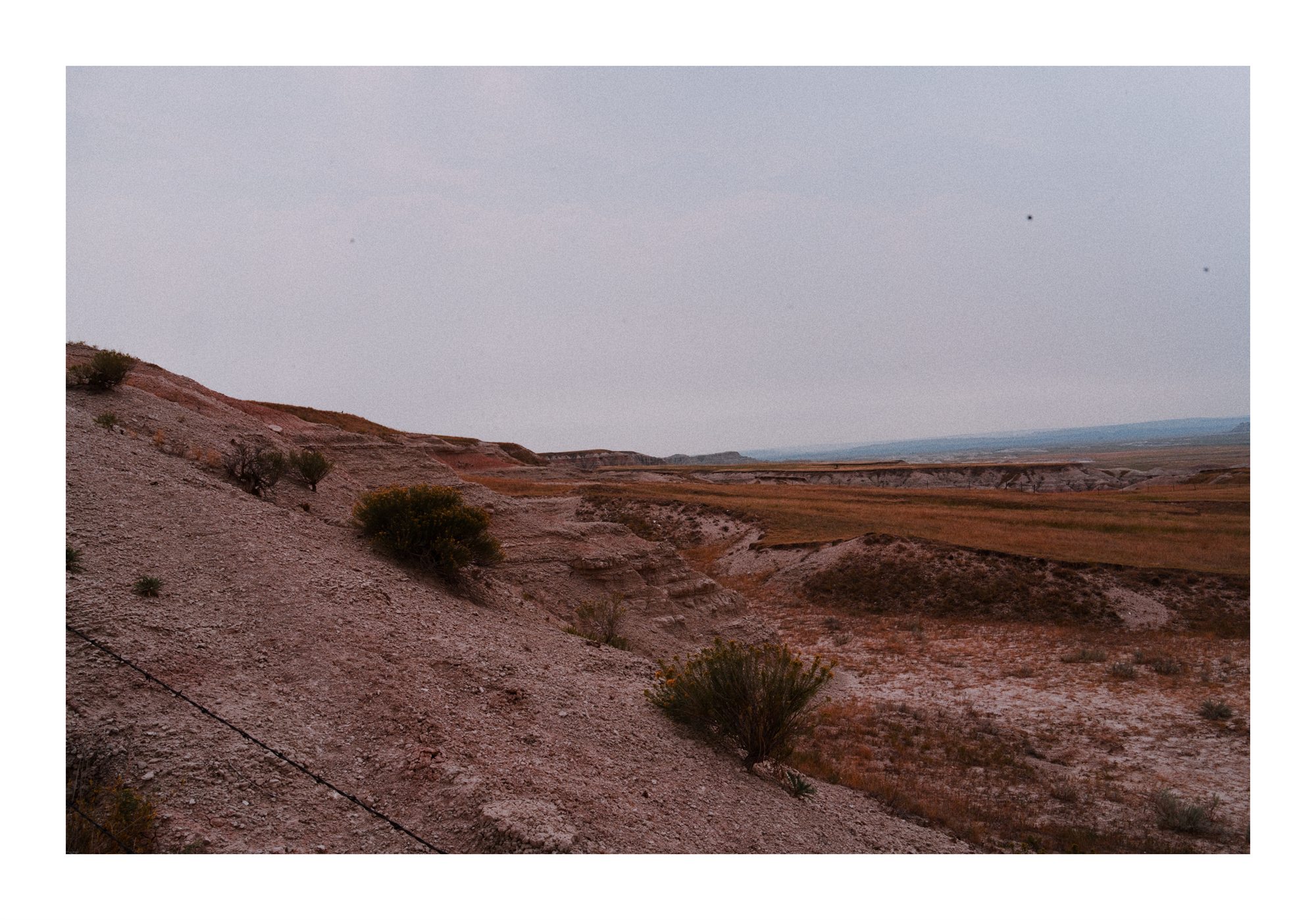 Muted badlands and open South Dakota landscape photographed during the Sturgis and Black Hills trip.